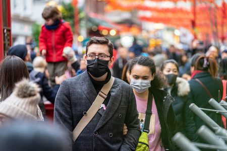 people walking down street with mask