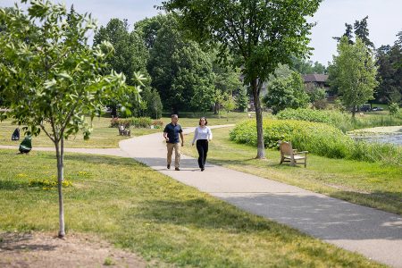 two people walking in a park