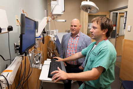 Joe Koopmeiners and Mike Puskarich discuss STOP-Sepsis study data in the HCMC emergency room.