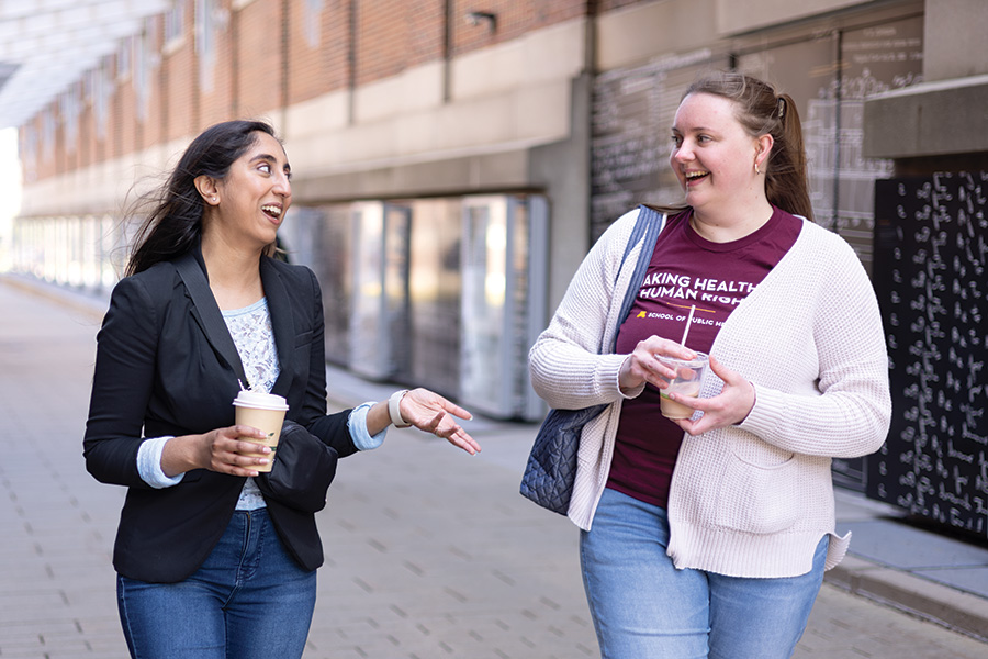 Asha Elgonda and Madie Cordell chatting and smiling