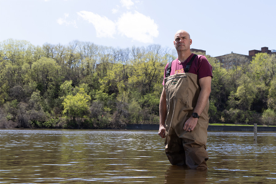 Matt Simcik standing in river with waders on