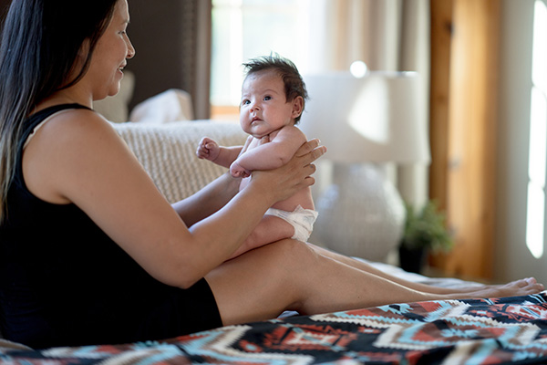 woman (maybe?) holding baby human